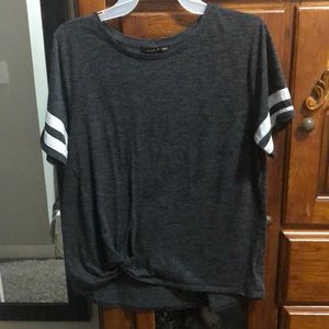 Gray and white shirt with a knot in the bottom.